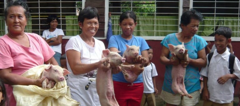 The mothers at the Atmosphere Soup Kitchen showing off their Piggy Bank