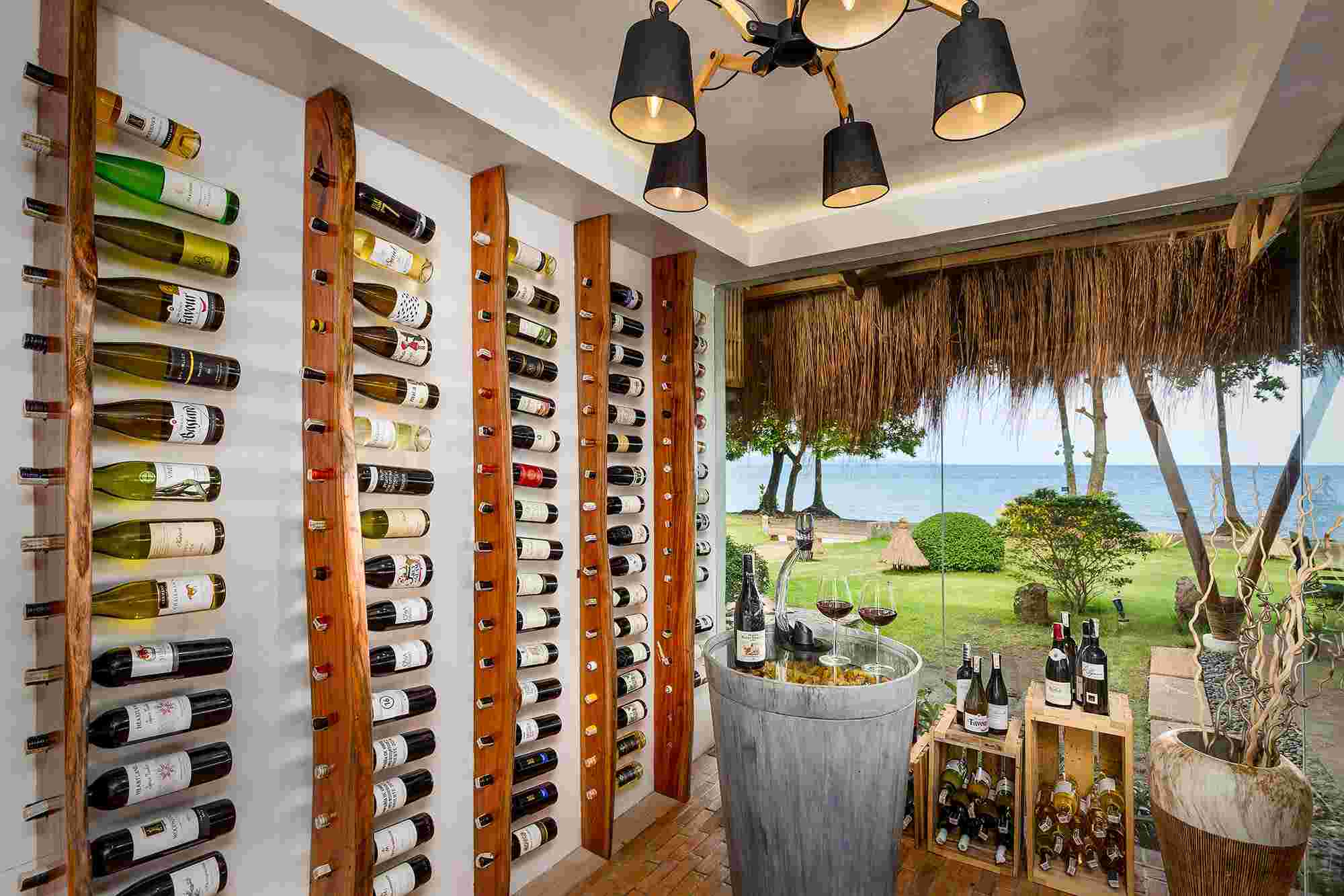 A selection of wine in a wine cellar overlooking the ocean in the tropics in the Philippines at Atmosphere Resorts & Spa.